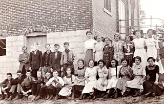 Monticello High School, circa 1912. Maud Legler is 3rd from the right in the back row. Mata Steinmann has her arm over Hilda Dick's shoulder. Others are unidentified..